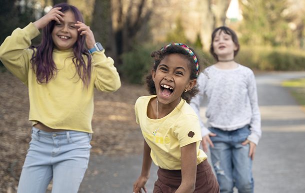 Three girls laughing and having fun outdoors