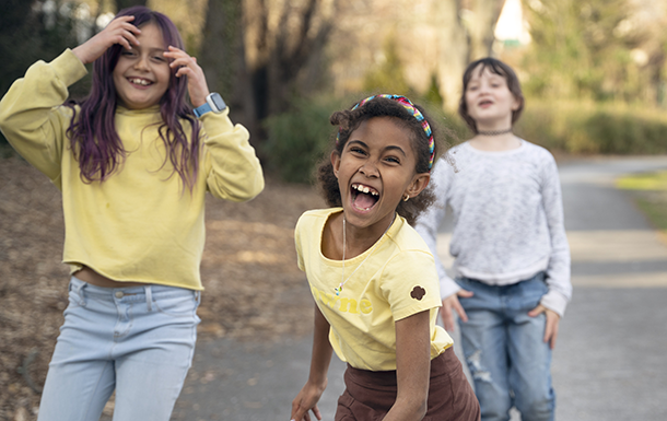 Three girls laughing and having fun outdoors