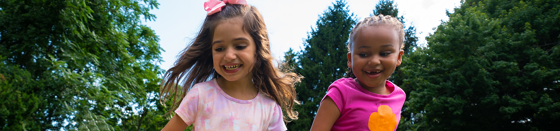  Two Brownie Girl Scouts running outside and laughing 