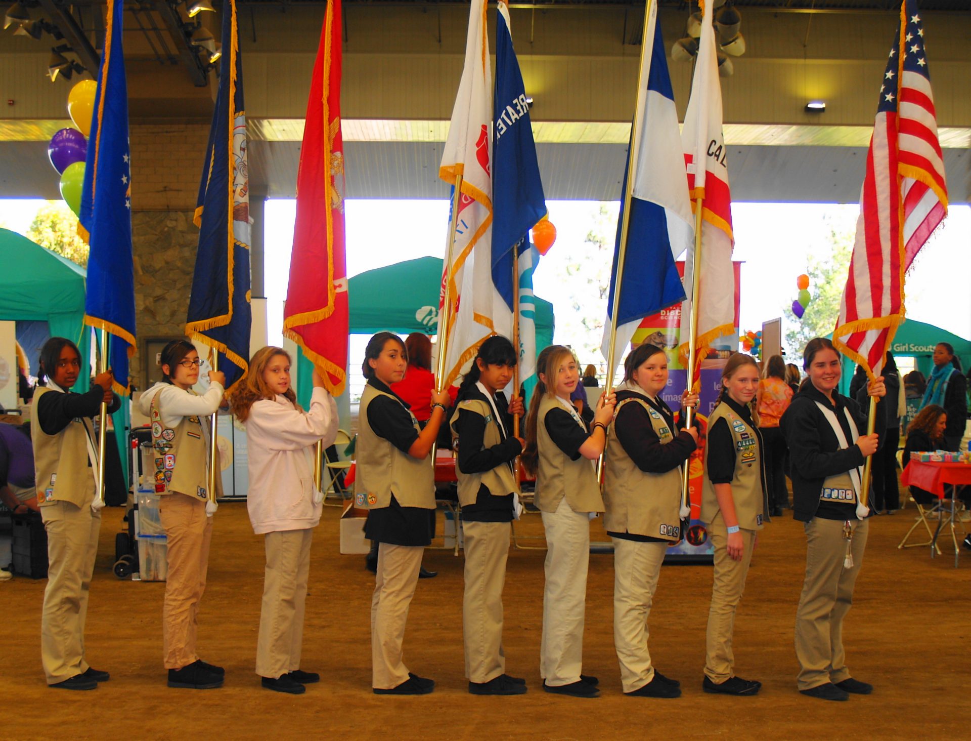 group of girl scouts with hands on top of each other